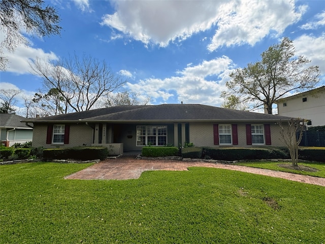 view of front of home with brick siding and a front lawn