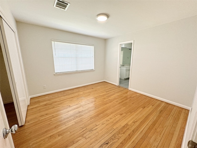 unfurnished bedroom with light wood-style flooring, baseboards, visible vents, and a closet