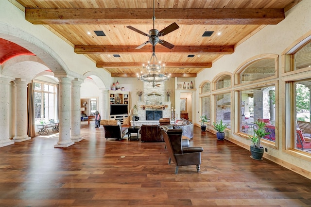 living room featuring decorative columns, a fireplace, arched walkways, dark wood-style flooring, and wood ceiling