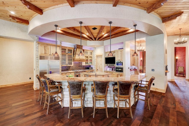 kitchen featuring a spacious island, beam ceiling, wood ceiling, and an inviting chandelier