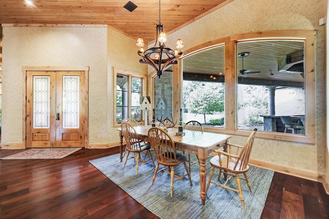 dining area with dark wood-style floors, baseboards, an inviting chandelier, wood ceiling, and french doors