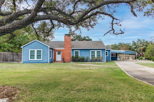 ranch-style house with fence, roof with shingles, a chimney, concrete driveway, and a front lawn