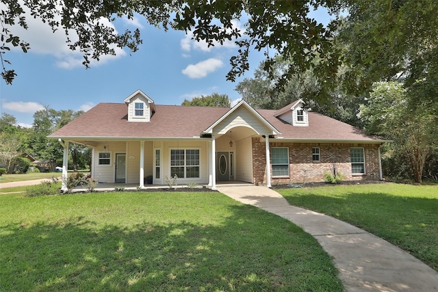 view of front of house with brick siding, roof with shingles, and a front lawn