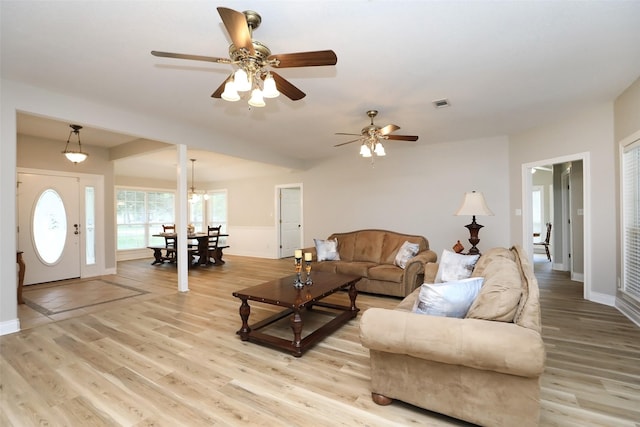 living area featuring visible vents, ceiling fan, baseboards, and light wood-style floors