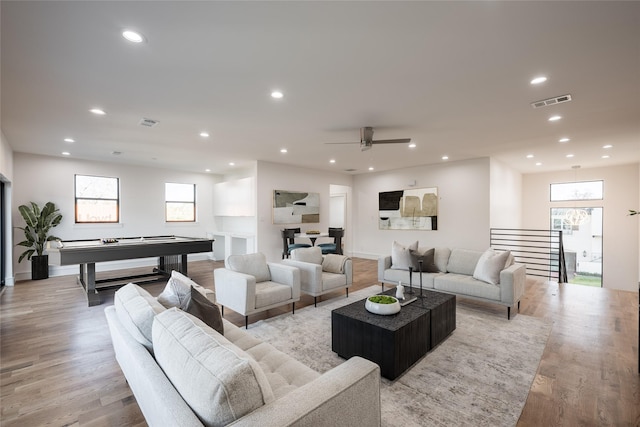 living area featuring recessed lighting, a healthy amount of sunlight, pool table, and light wood finished floors