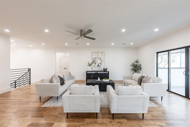 living area with recessed lighting, light wood-style flooring, baseboards, and a ceiling fan