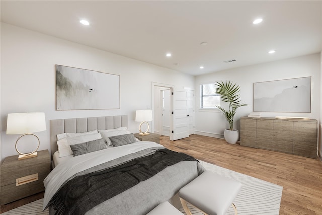 bedroom featuring recessed lighting, visible vents, light wood finished floors, and baseboards