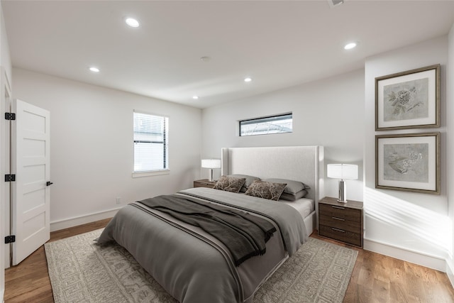 bedroom featuring recessed lighting, baseboards, and light wood-style flooring