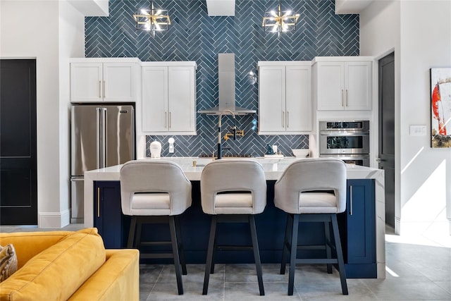 299 Peninsula Point Dr, Montgomery, TX 77356 - kitchen with wall chimney exhaust hood, freestanding refrigerator, an island with sink, white cabinets, and light countertops