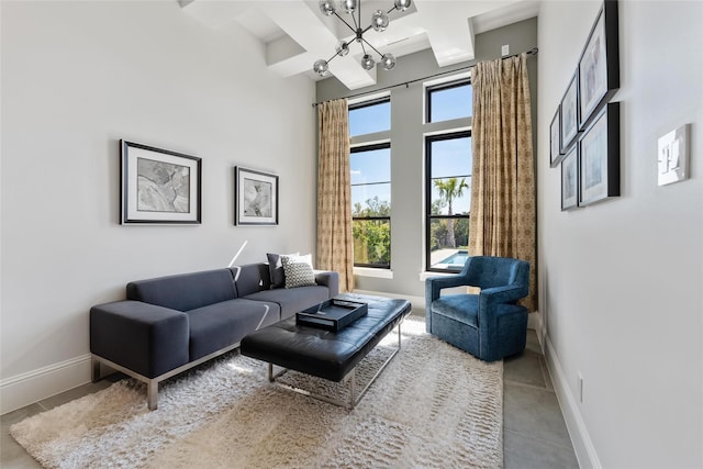 tiled living room featuring beamed ceiling, baseboards, coffered ceiling, and a high ceiling