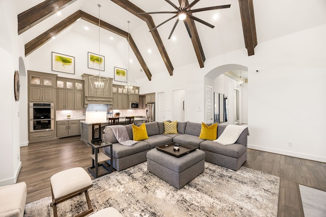 living area featuring beamed ceiling, high vaulted ceiling, dark wood-type flooring, arched walkways, and an inviting chandelier