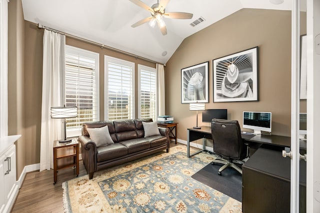 home office featuring visible vents, wood finished floors, baseboards, lofted ceiling, and ceiling fan