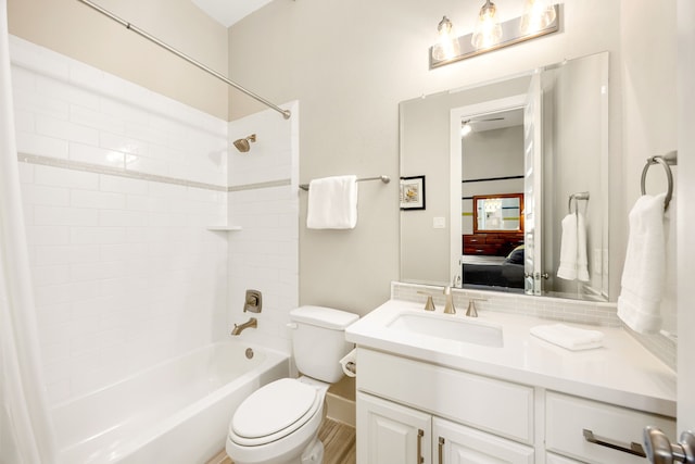 ensuite bathroom featuring vanity, ensuite bath, toilet, and shower / bathtub combination