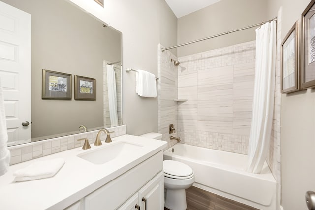 full bathroom with vanity, shower / bath combination with curtain, and toilet