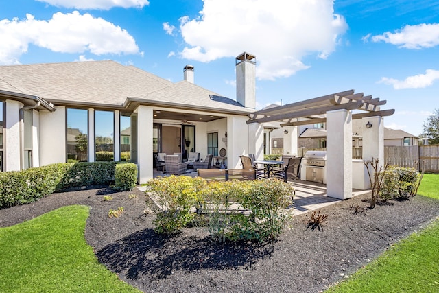 rear view of property with fence, an outdoor hangout area, an outdoor kitchen, a pergola, and a patio