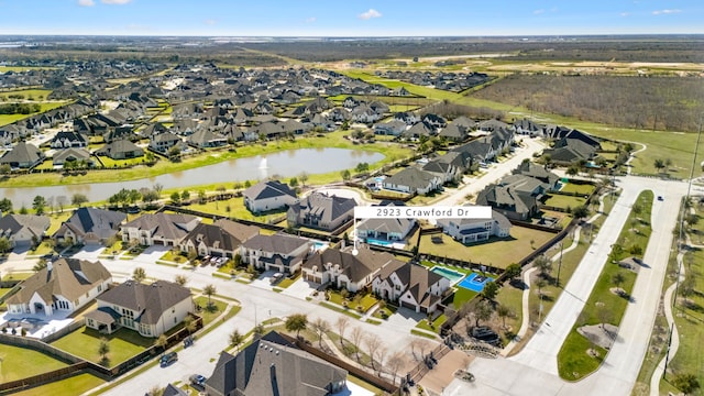 bird's eye view with a residential view and a water view