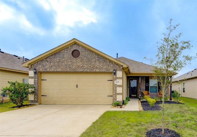 ranch-style home with driveway, an attached garage, a shingled roof, a front lawn, and brick siding