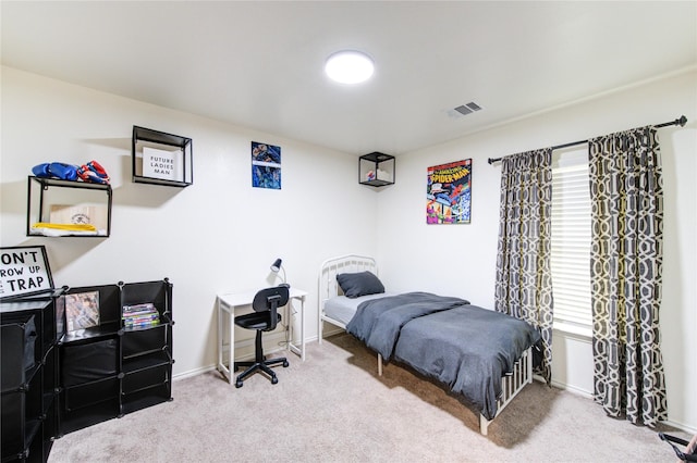 carpeted bedroom featuring visible vents and baseboards