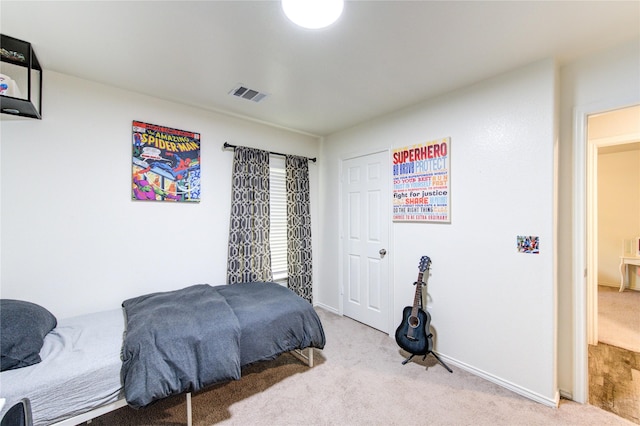 bedroom with visible vents, baseboards, and carpet