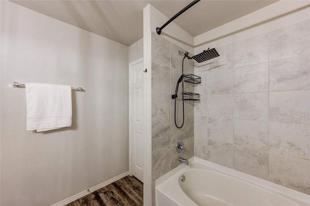 full bathroom featuring shower / tub combination, baseboards, and wood finished floors