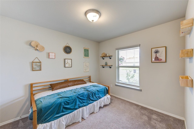 bedroom with baseboards and carpet floors