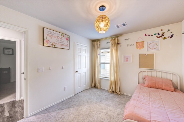 carpeted bedroom with baseboards and visible vents