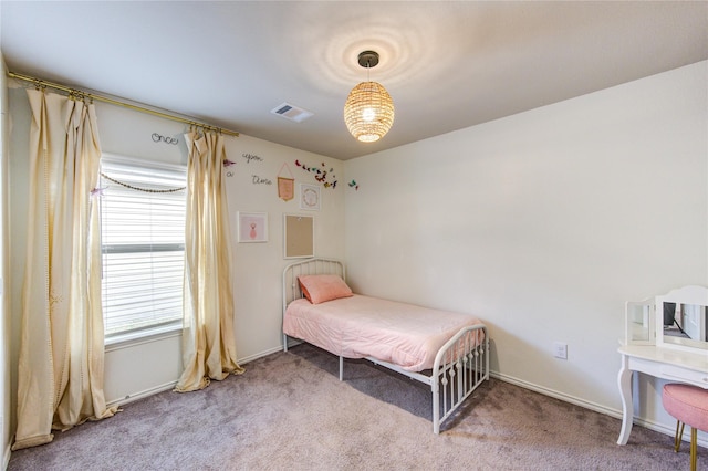 carpeted bedroom featuring visible vents and baseboards