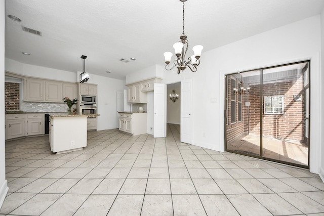 kitchen featuring stainless steel appliances, visible vents, a chandelier, and light tile patterned flooring