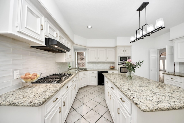 kitchen with under cabinet range hood, white cabinets, stainless steel appliances, and a sink