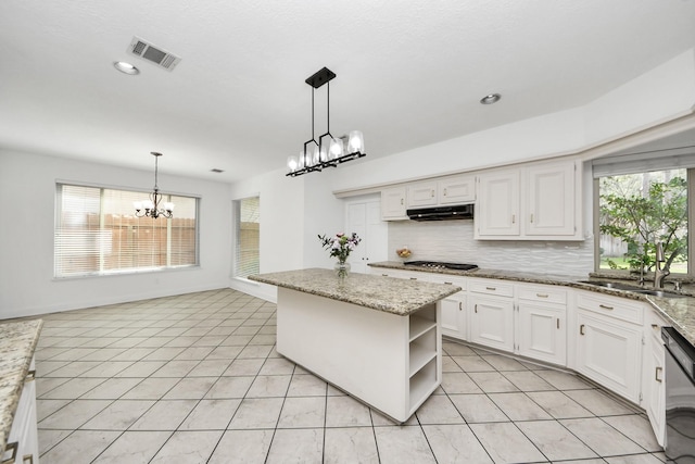 kitchen with visible vents, an inviting chandelier, open shelves, under cabinet range hood, and white cabinetry