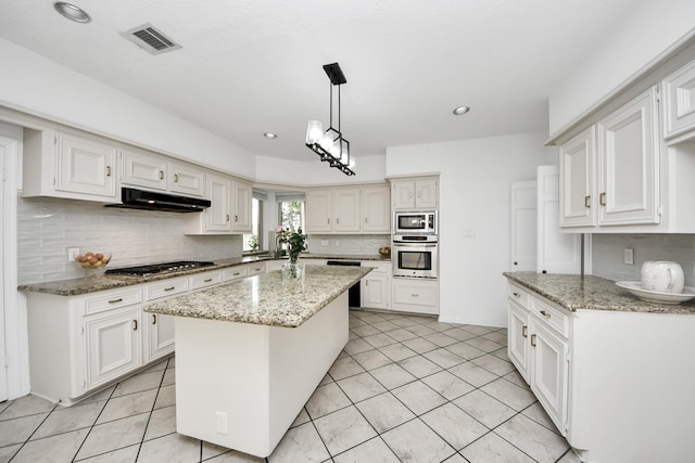 kitchen with under cabinet range hood, stainless steel appliances, visible vents, and white cabinets