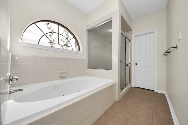 full bathroom with baseboards, a garden tub, a shower stall, and tile patterned flooring