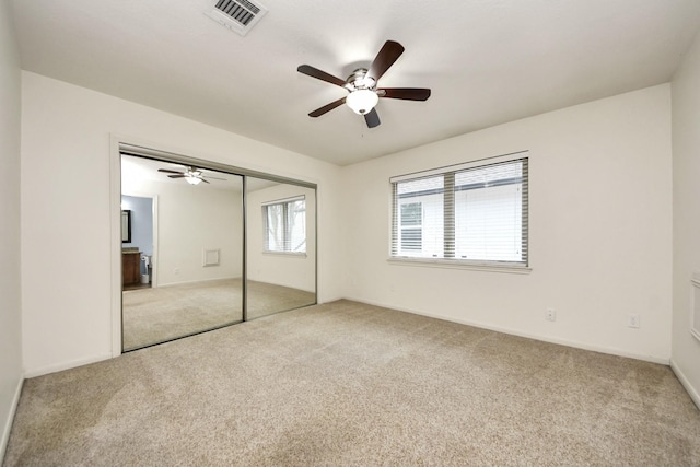 unfurnished bedroom with visible vents, a closet, and carpet flooring