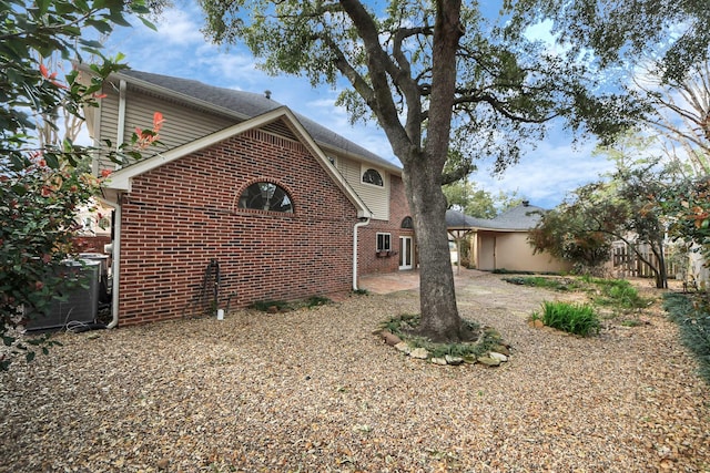 view of side of home with brick siding