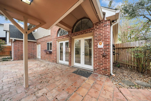 view of patio featuring french doors and fence