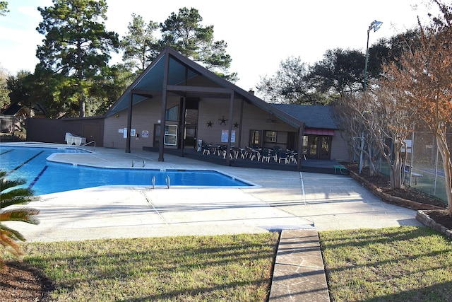 community pool featuring a patio and fence