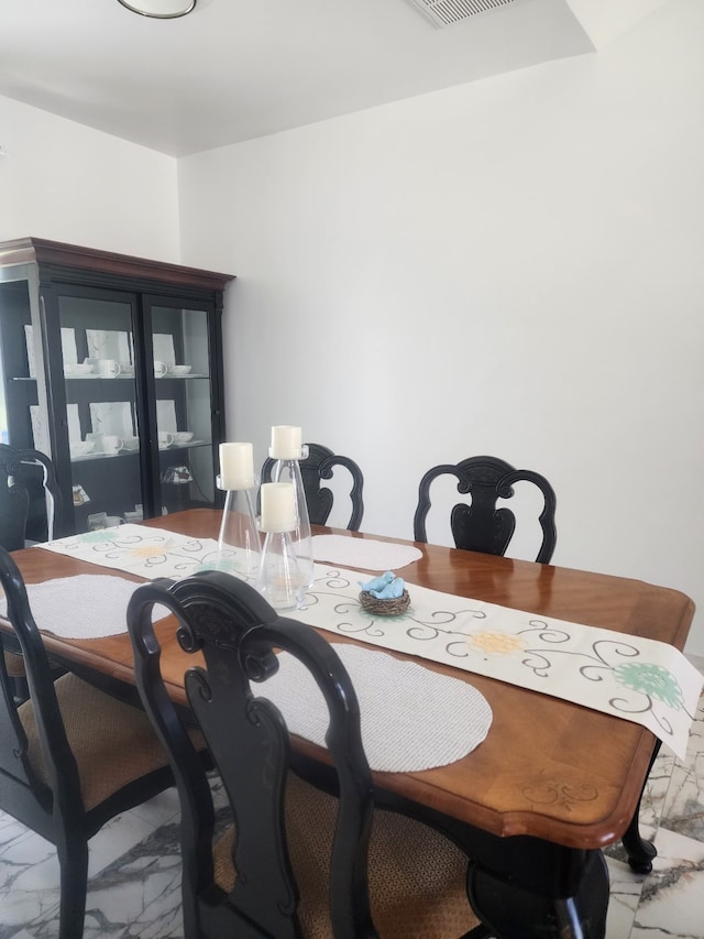 dining area with visible vents and marble finish floor