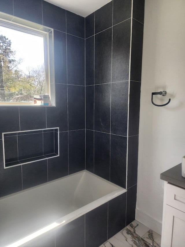 full bathroom with vanity, baseboards, and marble finish floor