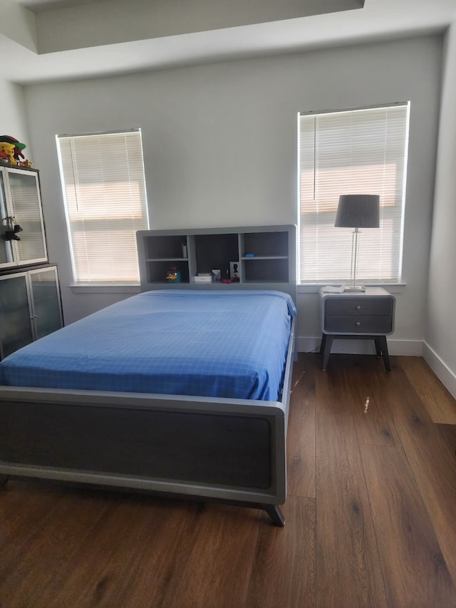 bedroom featuring baseboards and hardwood / wood-style flooring