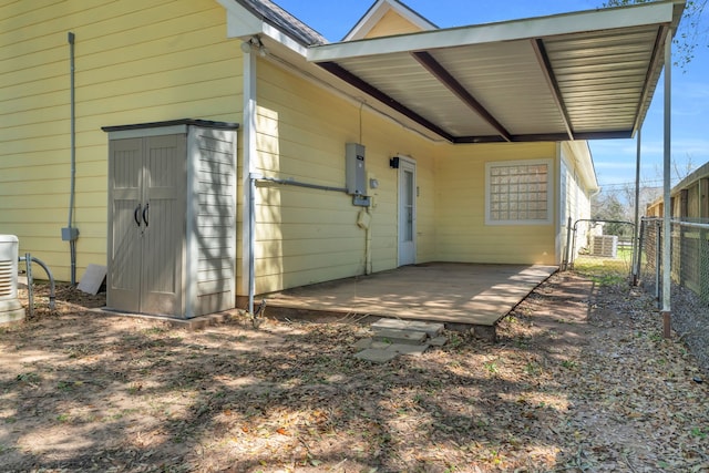 exterior space featuring an attached carport and fence