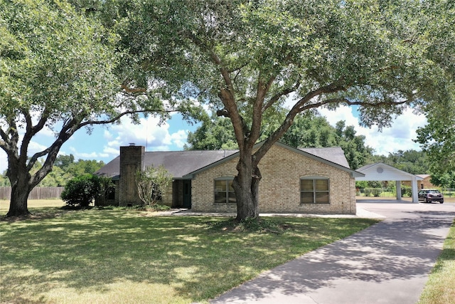 view of front of home with a front lawn, fence, brick siding, and a chimney