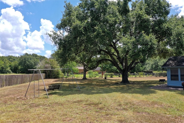 view of yard featuring a playground and fence