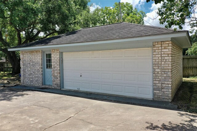 detached garage featuring fence