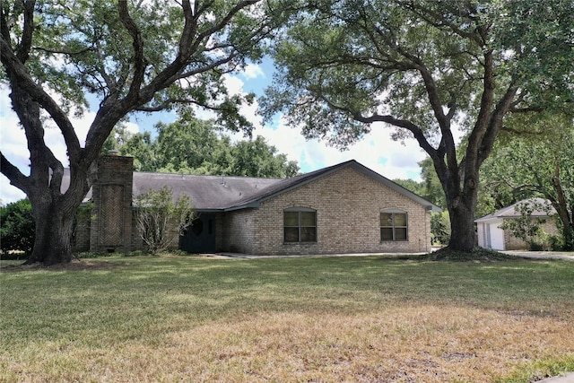 single story home with a front yard and brick siding