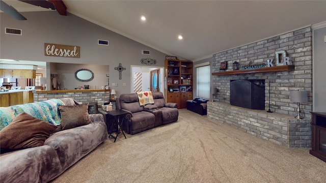 carpeted living area with visible vents, a brick fireplace, beamed ceiling, and ornamental molding