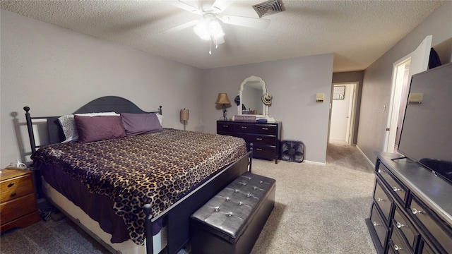 bedroom featuring visible vents, carpet flooring, a textured ceiling, and a ceiling fan