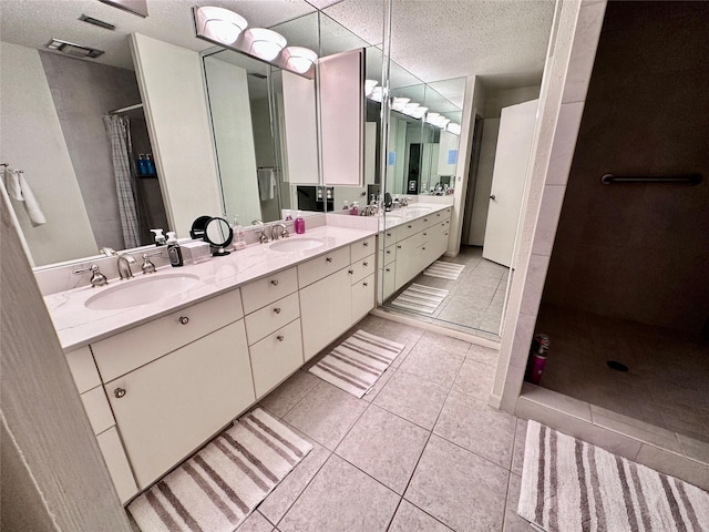 bathroom with tile patterned floors, curtained shower, double vanity, and a sink