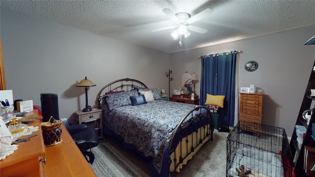 bedroom with a ceiling fan, carpet floors, and a textured ceiling