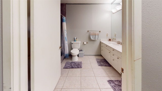 full bath with vanity, a shower with shower curtain, baseboards, tile patterned floors, and toilet