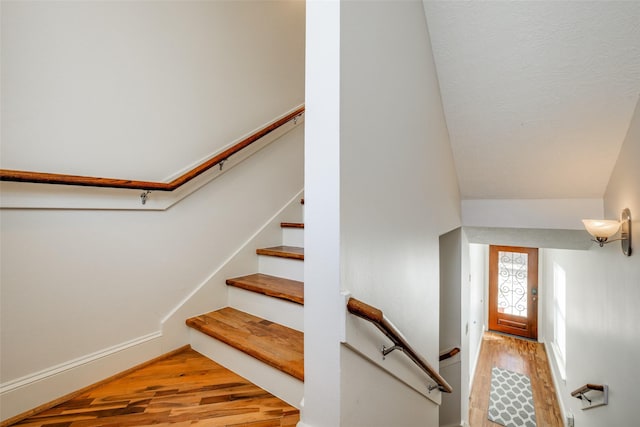 stairs with baseboards and wood finished floors